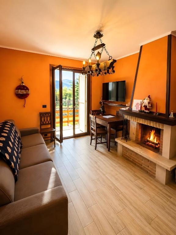 a living room with a couch and a fireplace at Stef House in Rivisondoli