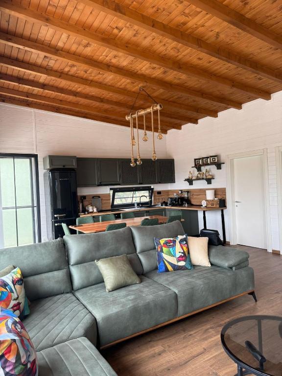 a living room with a couch and a kitchen at Vila KEY-A in Borsh
