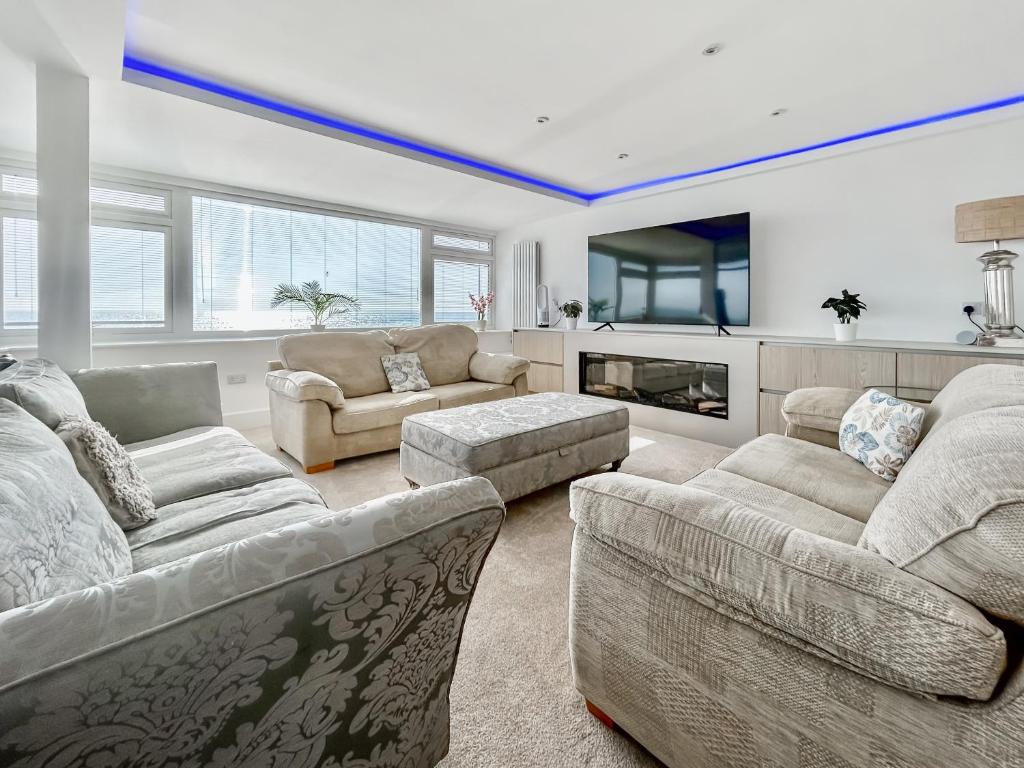 a living room with two couches and a fireplace at The Beach House in Worthing