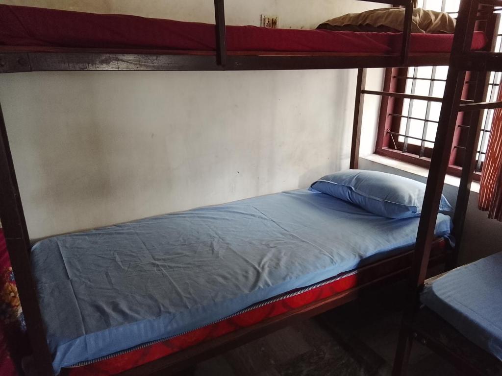 a bedroom with two bunk beds and a window at CK Enclave in Tripunittura