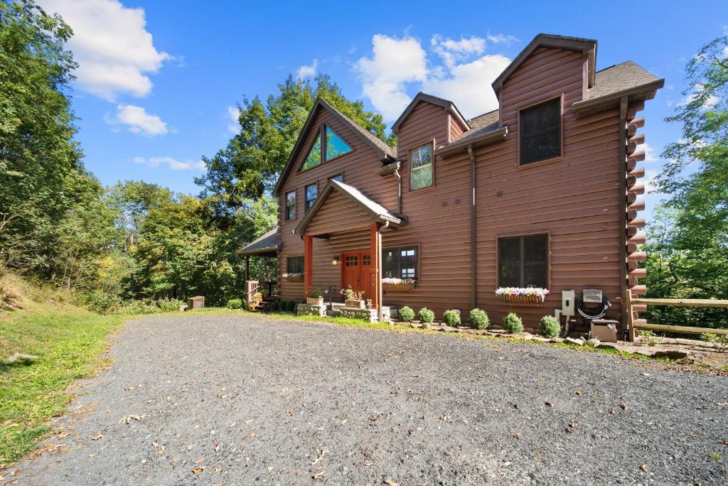 a large wooden house with a gravel driveway at Cranberry View Lodge in Newland