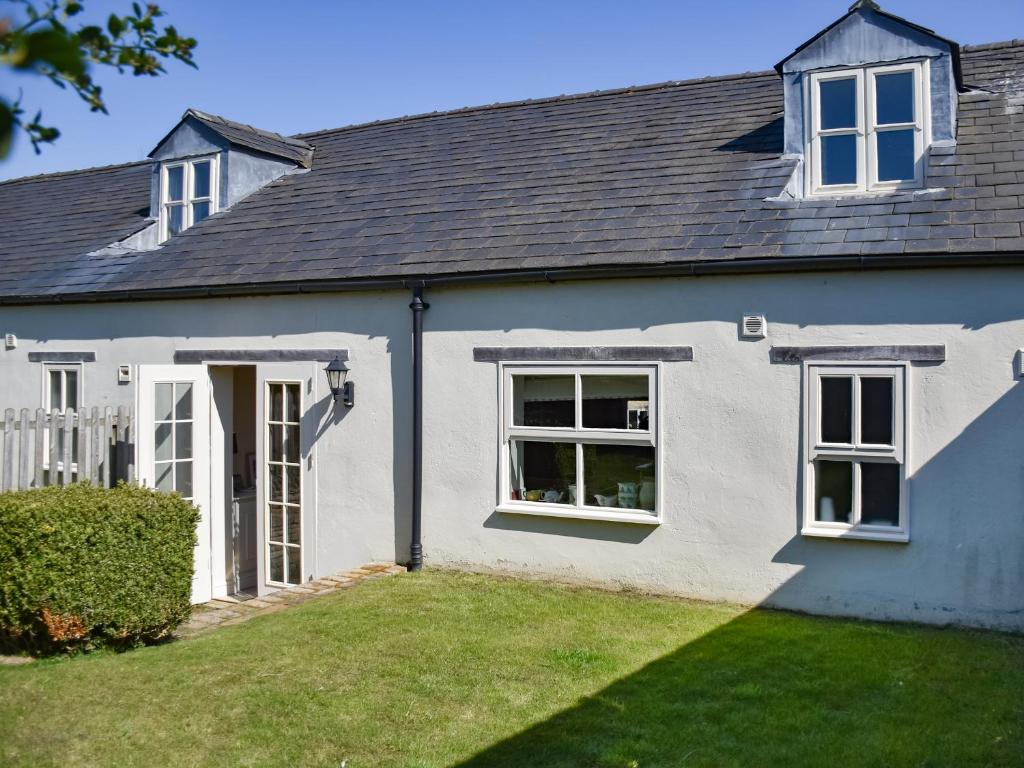 a white house with a door and a yard at Lily Pad 1 - Uk49648 in Nassington