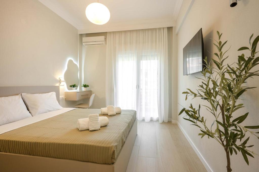 a bedroom with a bed with two towels on it at Elia Apartments in Ierissos
