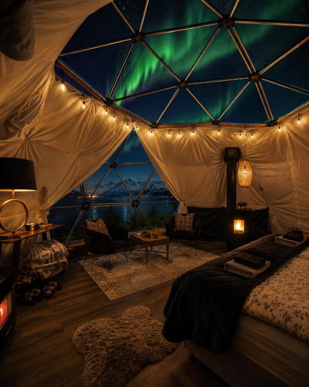 a room with a tent with a green light in it at Lyngenfjord View in Engnes