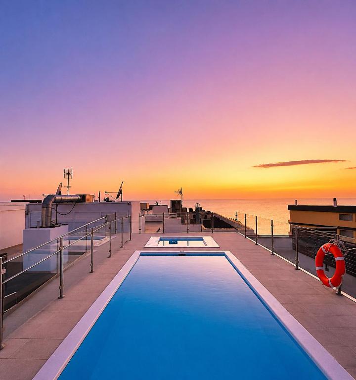 a pool on the deck of a cruise ship at sunset at Arguineguin Sun Beach in Arguineguín