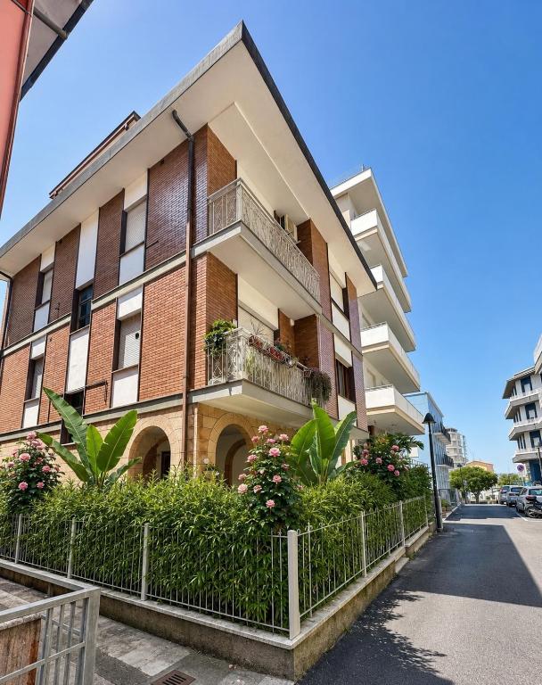 an apartment building with a balcony on a street at Appartamenti Gabicce Mare in Gabicce Mare