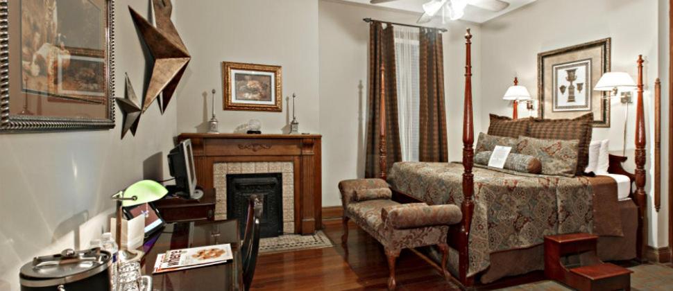 a living room with a bed and a fireplace at 1896 O'Malley House in New Orleans