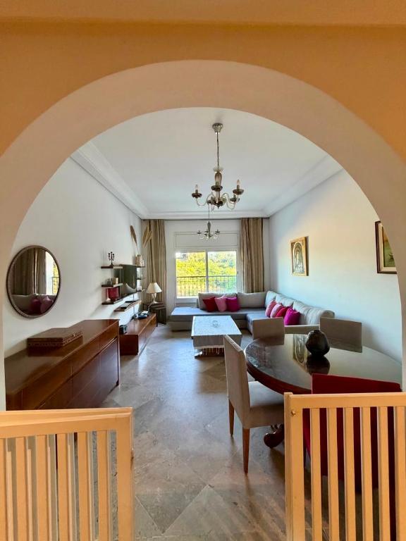 a living room with a table and a couch at Comfy 2Bdrs Marsa in Carthage