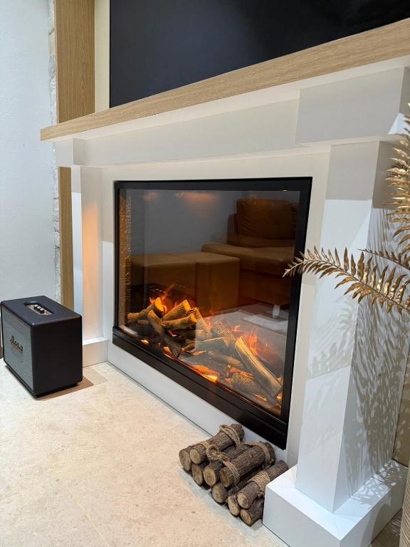 a fireplace with a fire inside of it at The Verona pool villa Hatyai in Ban Khlong Pleo