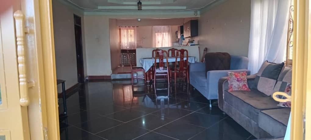 a living room with a couch and a table at Mirembe house in Mukono