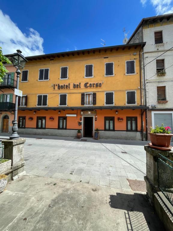 a large yellow building with a sign on it at Hotel del Corso in Sestola