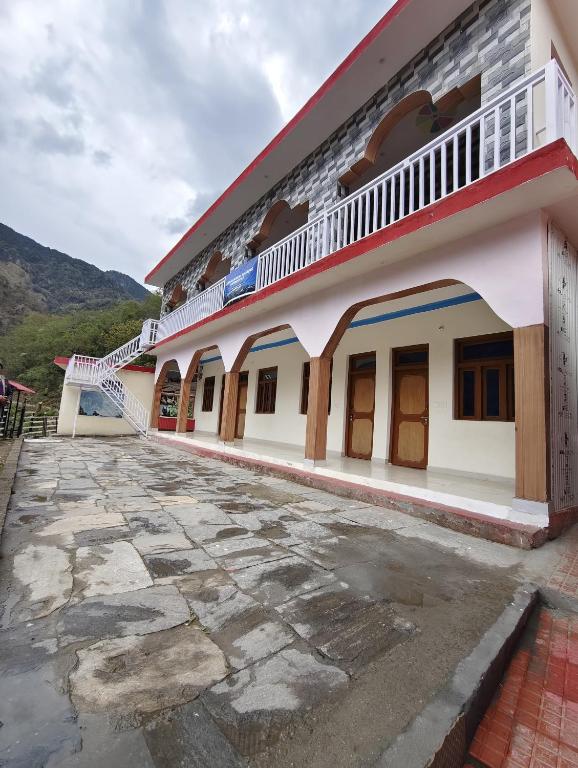 a view of a building with a stone courtyard at Himalayan due homestay chopta in Sari