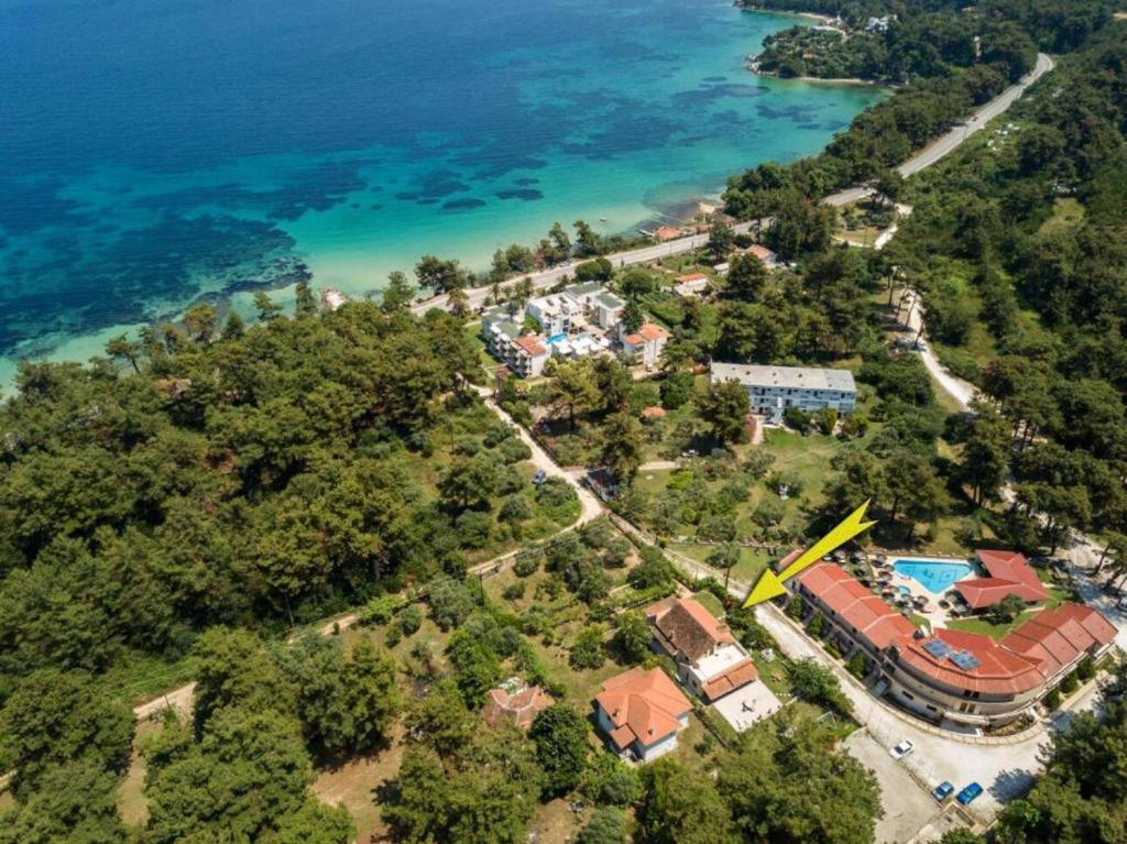 an aerial view of a house next to the water at green & blue villa in Glykadi