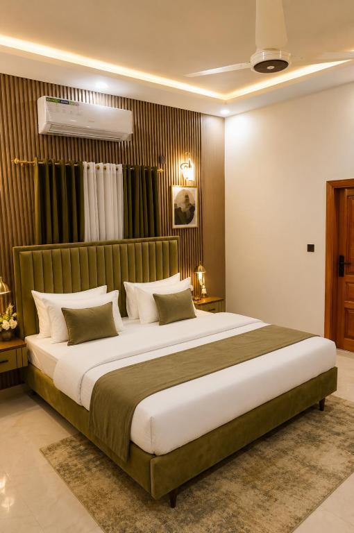 a bedroom with a large bed in a room at City rooms in Karachi