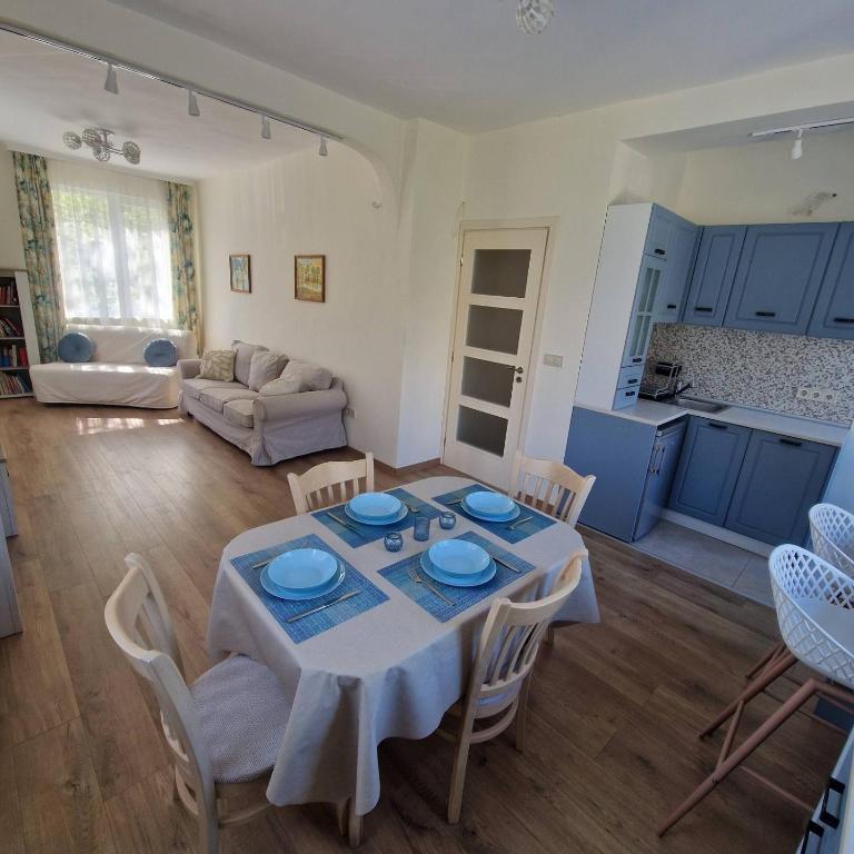 a kitchen and a living room with a table and chairs at Blue Dreams - City Center Burgas in Burgas