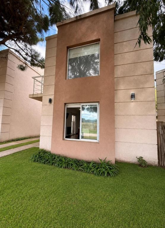 a house with a window on the side of it at Complejo del jaguel Reserva del Bosque in Santa Teresita
