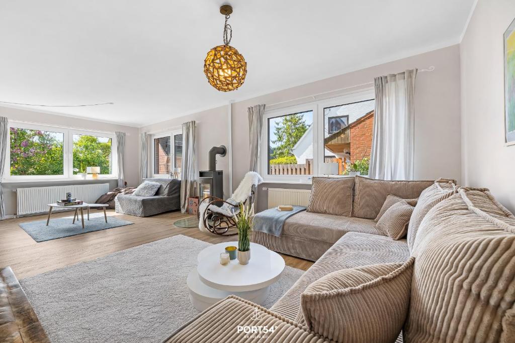 a living room with a couch and a table at Ferienwohnung Windjammer 5 St Peter-Ording in Sankt Peter-Ording