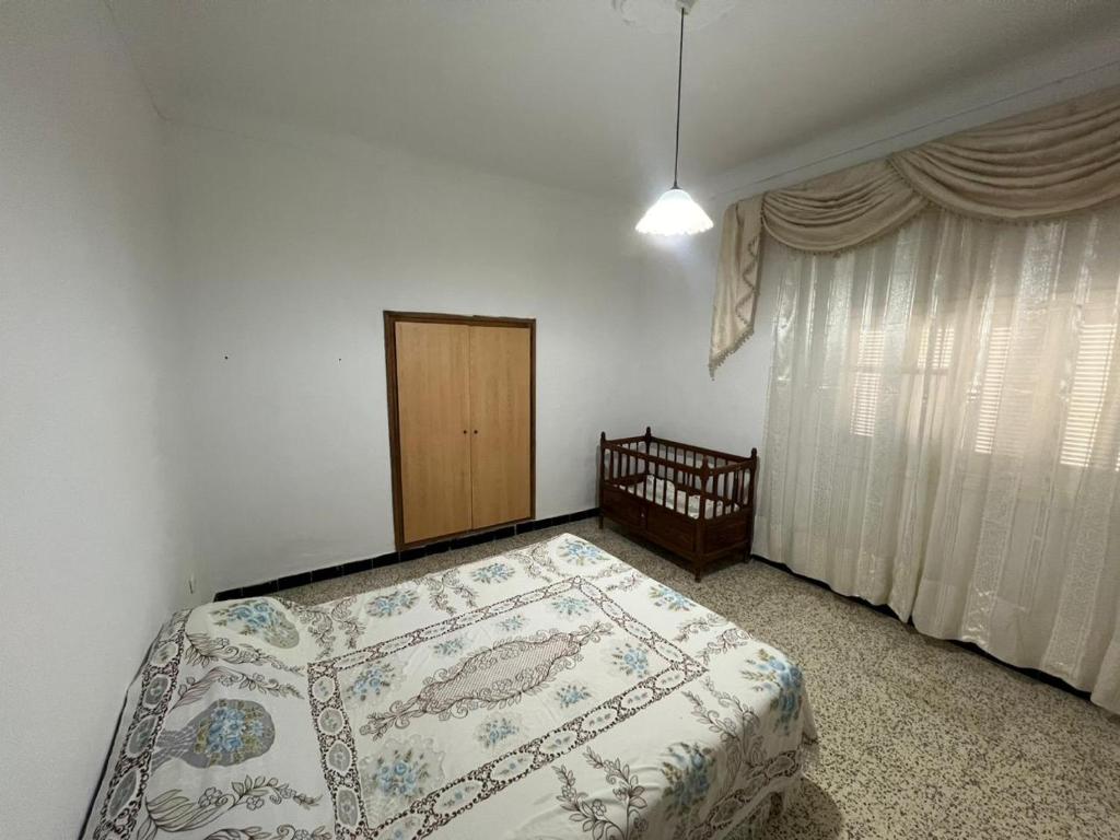 a bedroom with a bed and a window at Charmante maison à Hammamet, proche plage et commodités in Hammamet
