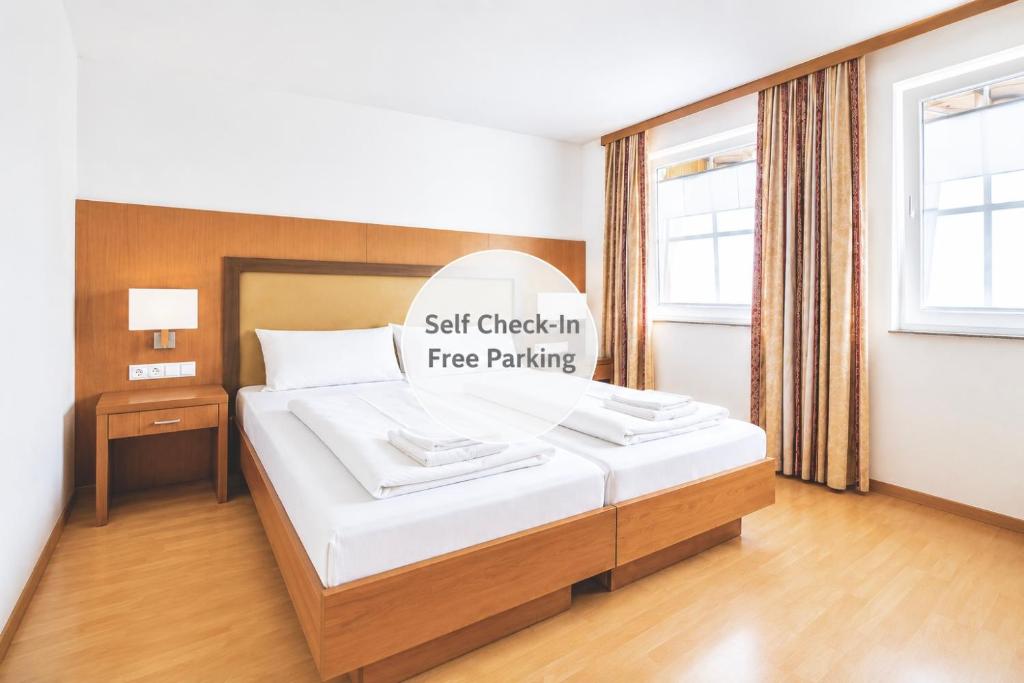 a bedroom with a bed with a sign that reads self check in free parking at Mühlengarten by Zzzimple in Nittel