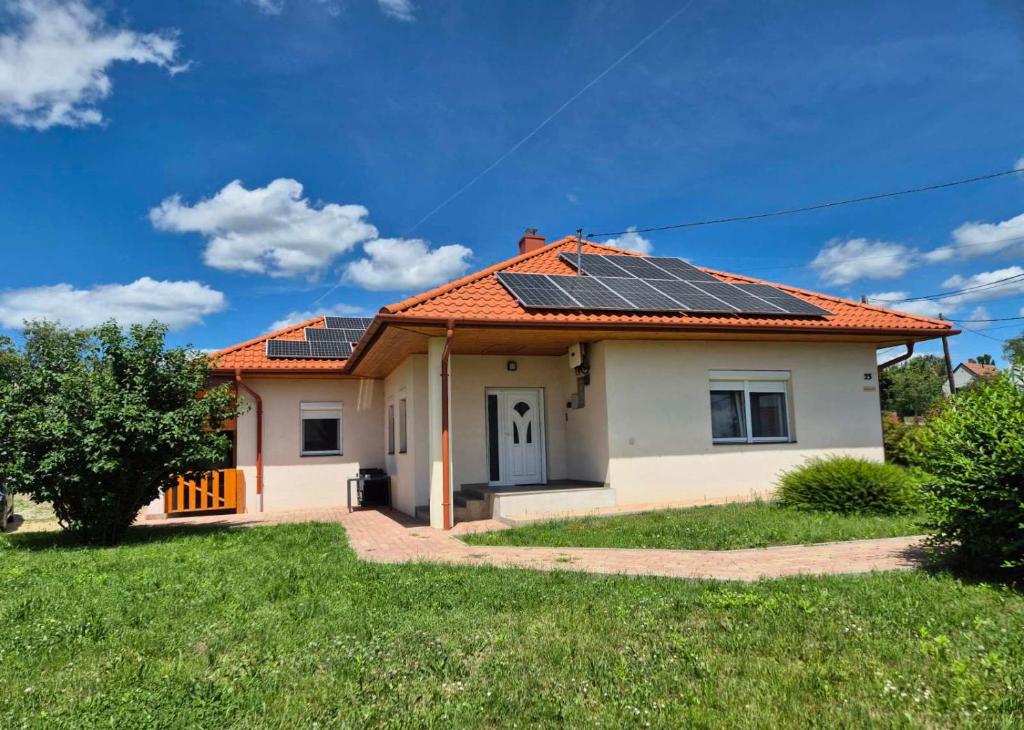 a house with solar panels on the roof at Barlang utca Villa in Cserszegtomaj
