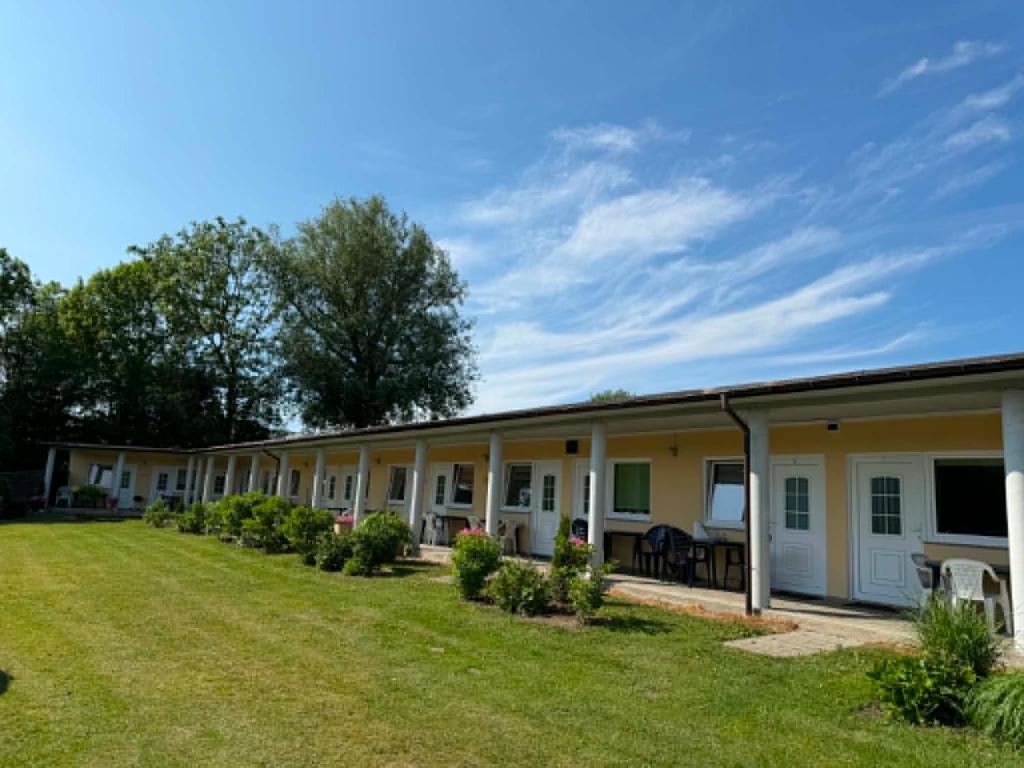 a row of barracks with a yard at POMERANIA Pokoje U Oliwii in Rewal