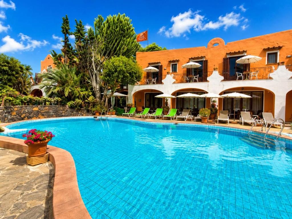 a large swimming pool in front of a building at Hotel Aragonese Ischia in Ischia Town