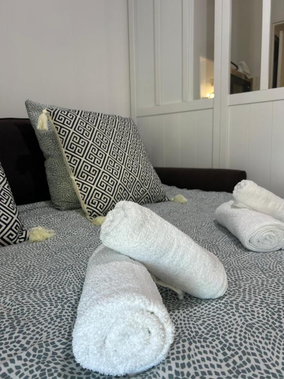 a bed with two white towels on top of it at 100m de la plage in La Grande Motte