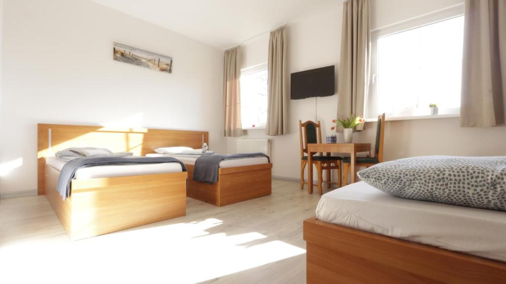 a hotel room with two beds and a table at Baltic Resort - Korsarz in Darłowo