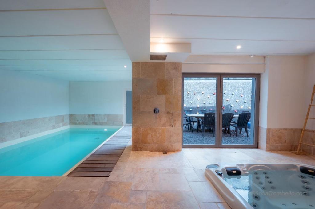 a swimming pool in a house with a dining room at Les Gîtes de Sprimont - Le Cosy in Sprimont