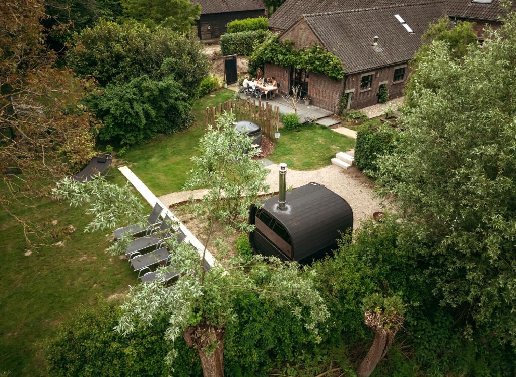 an aerial view of a yard with a grill and chairs at Sterrenbos wellness lodge in Beers