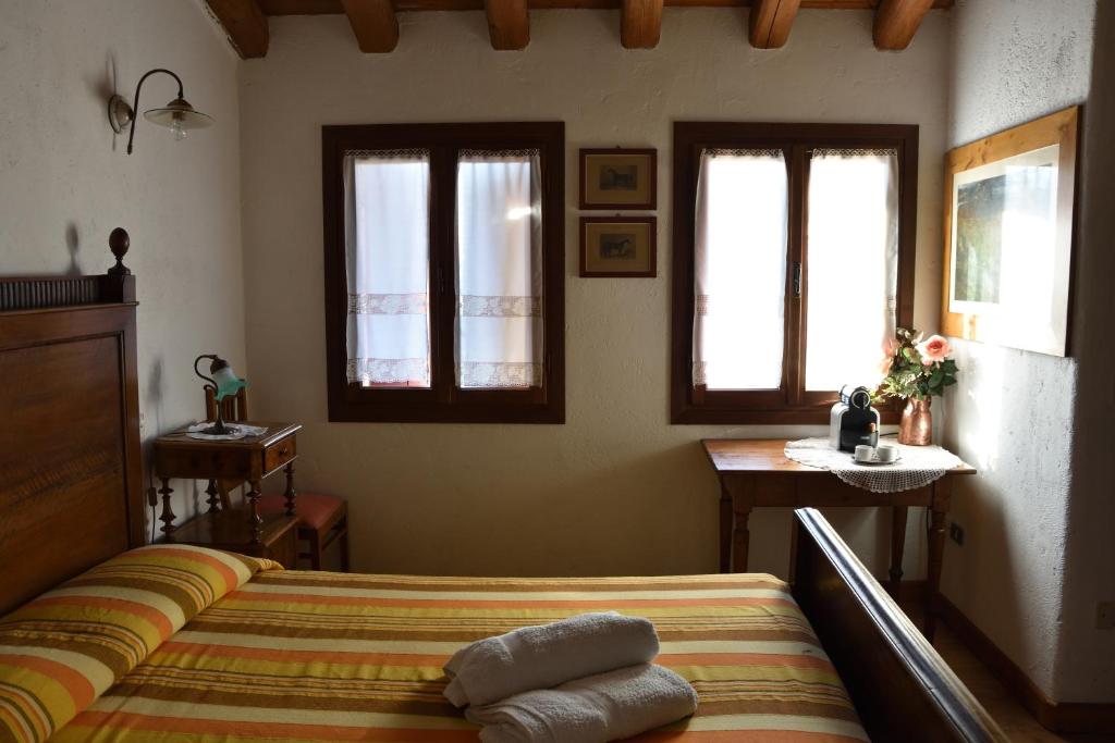 A bed or beds in a room at Ca Borgh