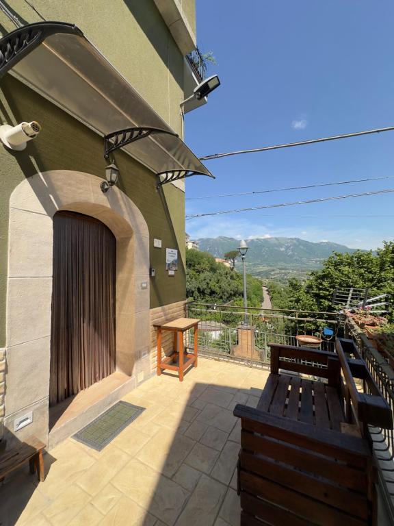 a patio with a bench and a building at Casa Vacanze Il Vicolo - Oliveto Citra in Oliveto Citra