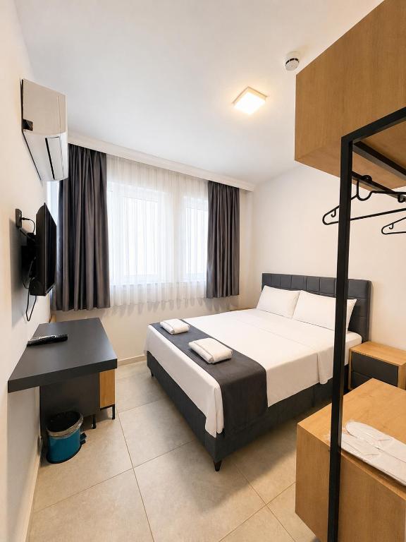 a hotel room with a bed and a desk at Kaya Hotel in Antalya