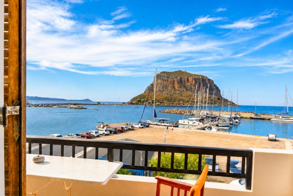 a balcony with a view of a marina at Matroni's House - Seafront Getaway in Monemvasia in Monemvasia