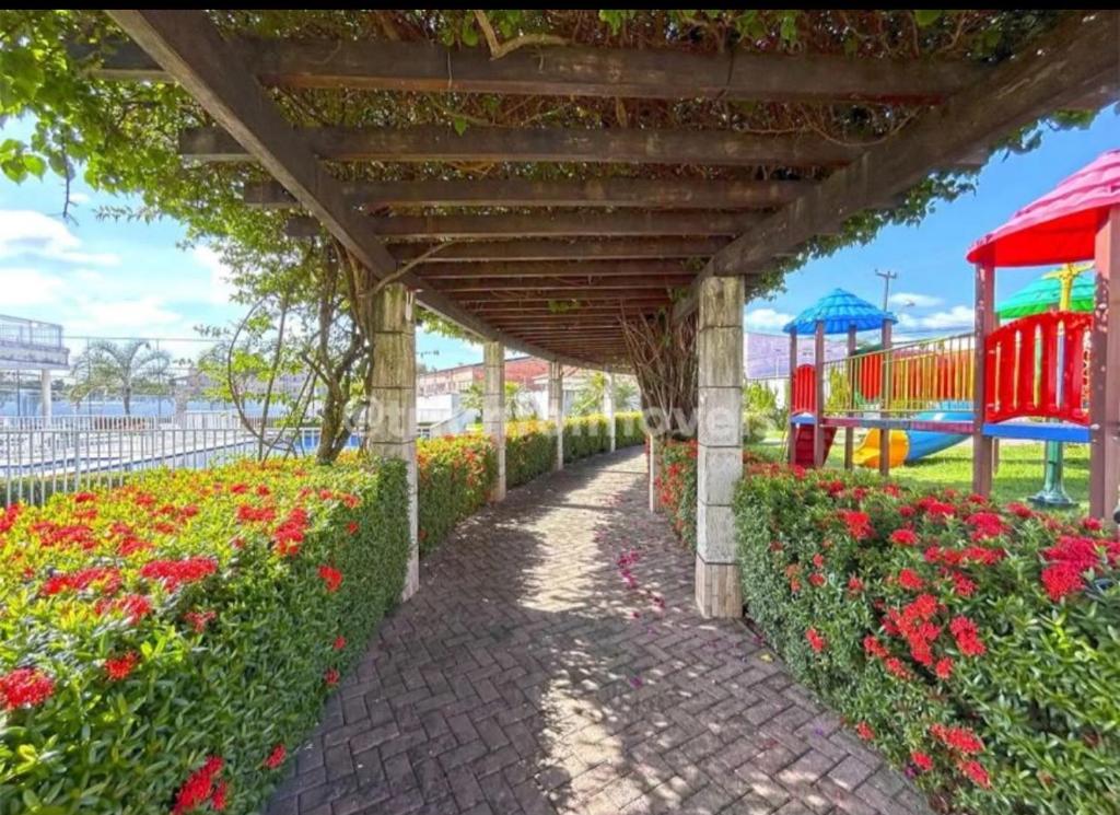 a pathway in a park with a playground at AP da Vicky 2 quartos central São Luis in São Luís