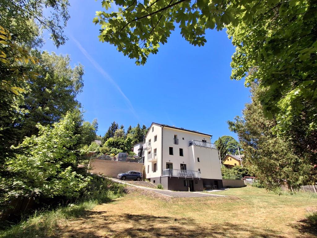 a white building on the side of a road at Residence Pod Bublavou in Kraslice
