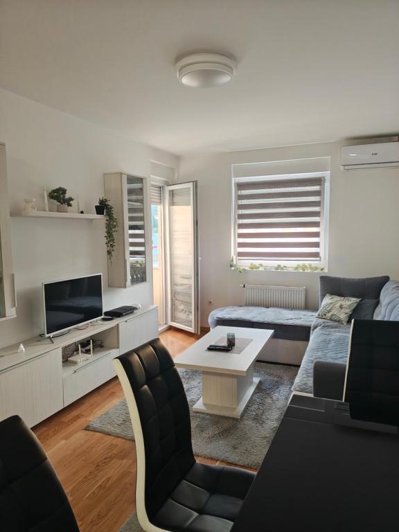 a living room with a couch and a tv at Urban escape in Doboj
