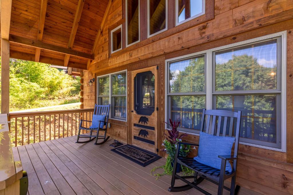 two chairs on a porch of a wooden cabin at Beaver Rock Lodge in Elk Park
