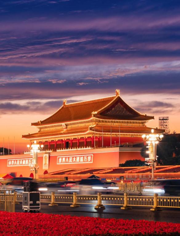 a chinese building at night with traffic in front at 北京三里屯天安门亚朵酒店 in Beijing