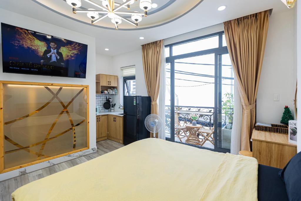 a bedroom with a large bed and a large window at Four P Home in Ho Chi Minh City