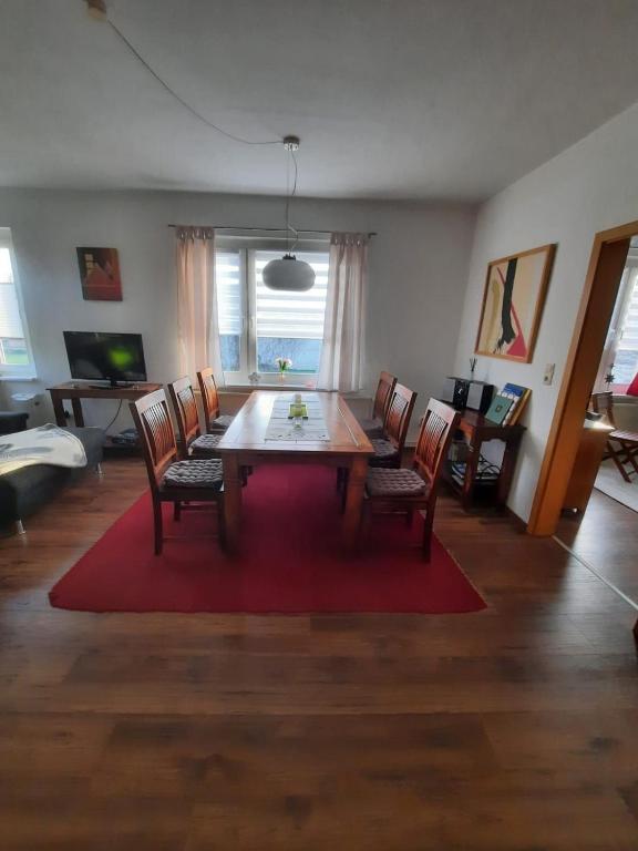 a living room with a wooden table and chairs at Ferienwohnung in Reuterstadt Stavenhagen