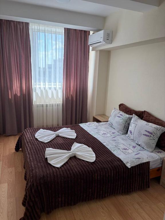 a bedroom with a bed with two white bows on it at Smart House Home in Kyiv