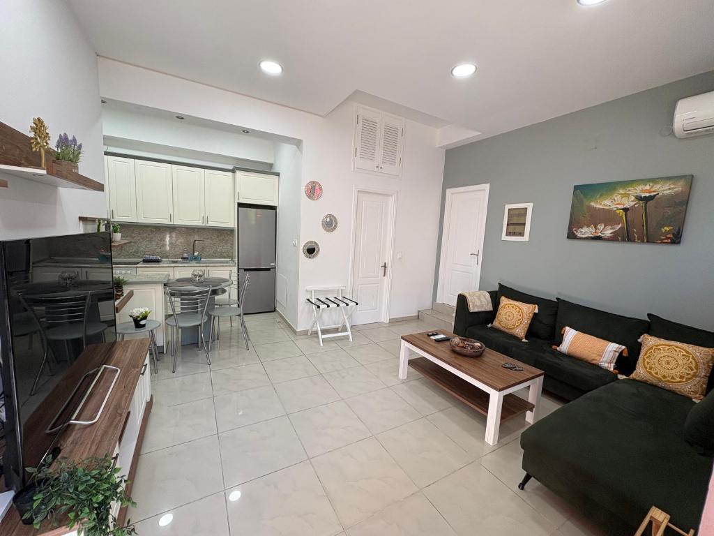 a living room with a couch and a table at Corfu Port Sweet Home in Mantoúkion