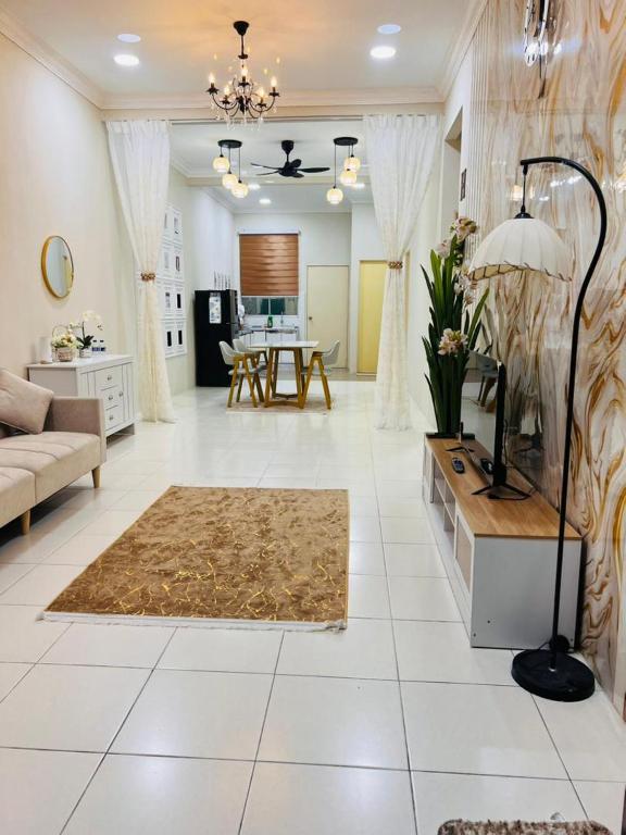 a living room with a couch and a table at Elora Homestay in Tampin