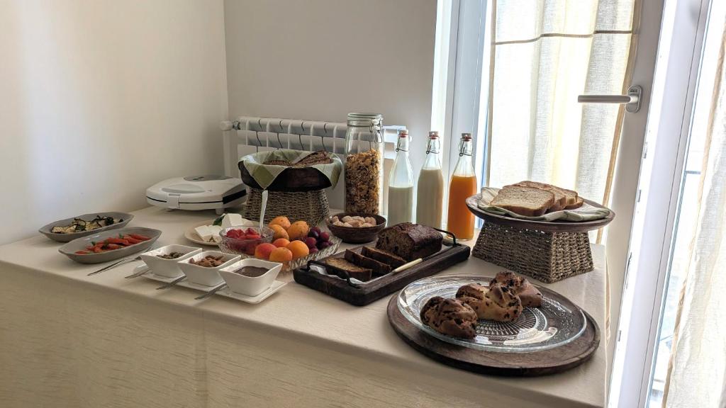 a table with a bunch of food on a window sill at Amati Bed & Breakfast in Lecce