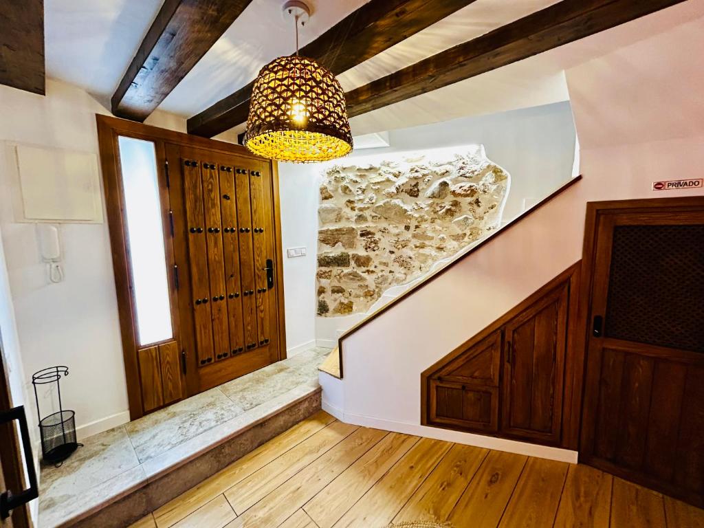 a room with a staircase with a door and a chandelier at Casa Cazorla in Ojén