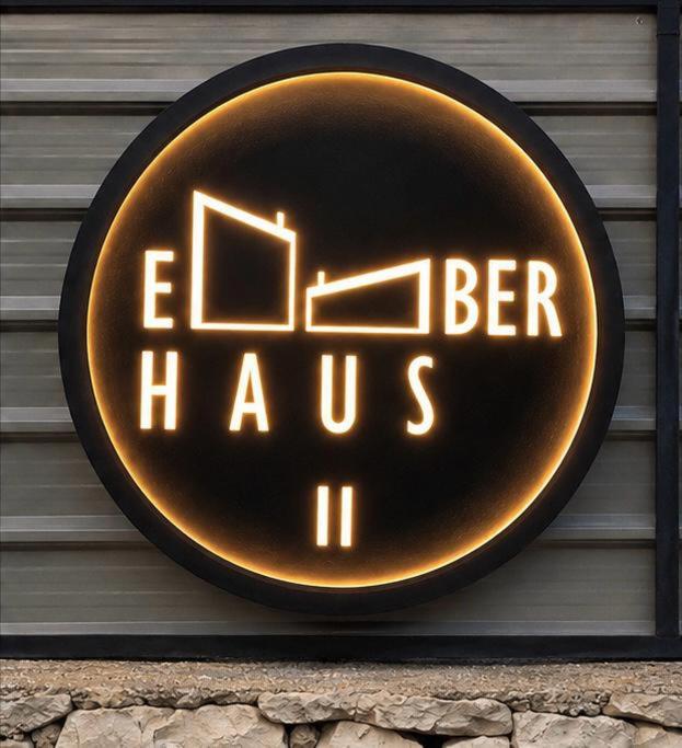 a sign that says elben haus on a wall at EmberHaus Retreat with Private Pool in Kafr ‘Ubaydā