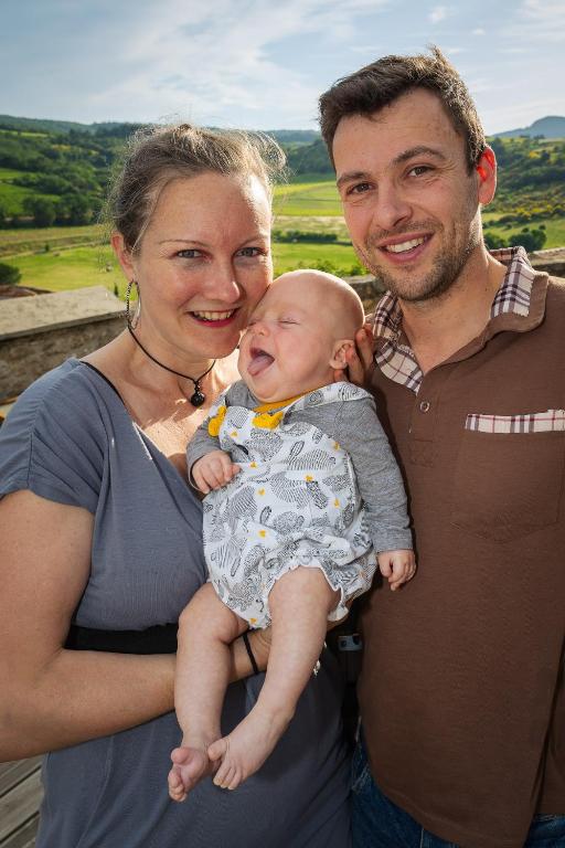 a man and a woman holding a newborn baby at Au Château de Villelongue B&B in Villelongue-dʼAude