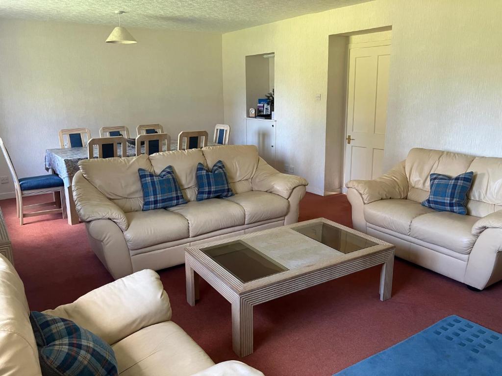 a living room with couches and a coffee table at Ardmuir in Turriff