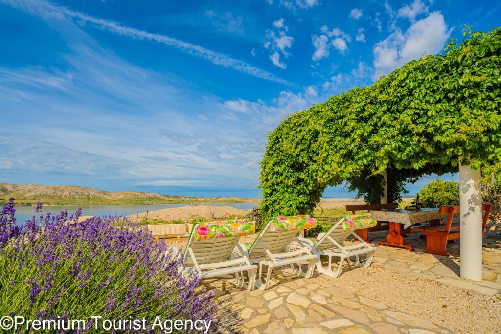 a group of chairs and a table with flowers at Milena Sea & Mountain View in Zubovići